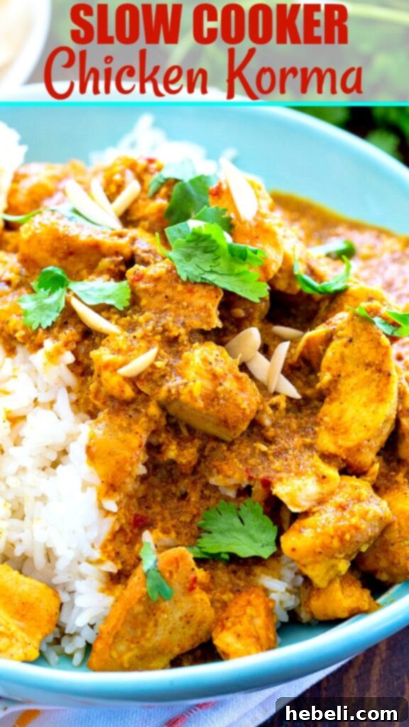 Close-up of Slow Cooker Chicken Korma with naan bread and rice, invitingly presented.