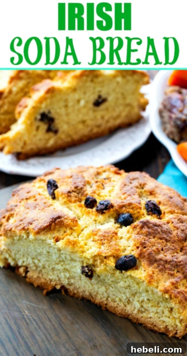Traditional Irish Soda Bread 6 A large, rustic loaf of Irish Soda Bread, with a deep 'X' cut into the top, resting on a wooden board.