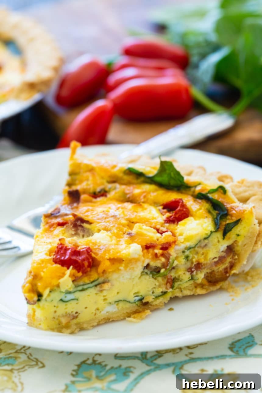 A whole BLT Quiche with a golden crust, rich filling, and visible ingredients like bacon, spinach, and tomatoes.