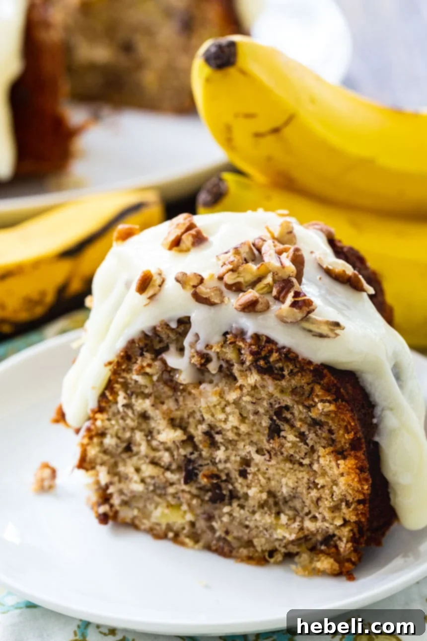 Southern Hummingbird Bundt 4 The finished Hummingbird Bundt Cake, showcasing the rich cream cheese glaze drizzled over its golden-brown surface.