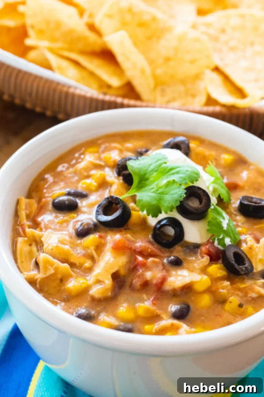A large batch of Crock Pot Chicken Tortilla Soup in the slow cooker.