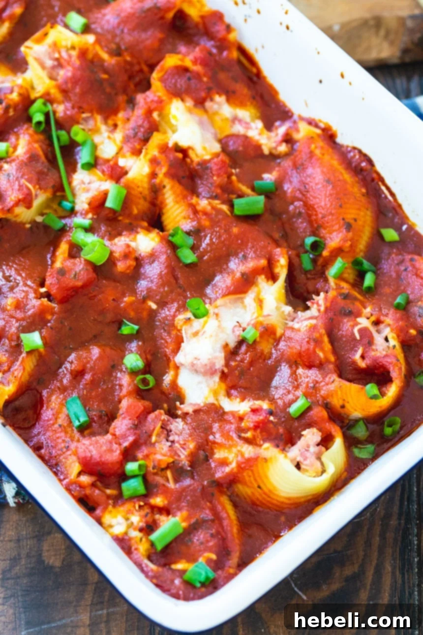 Close-up of Pulled Pork Stuffed Shells before baking, showcasing the rich filling.