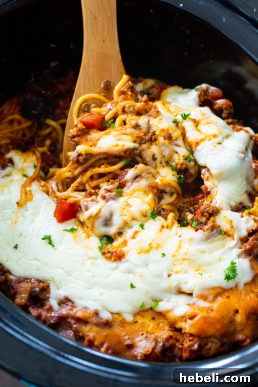 One-Pot Slow Cooker Spaghetti Dinner 4 Slow Cooker Spaghetti Casserole with ground beef and Italian sausage, ready to be served.