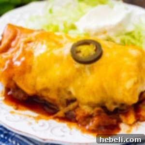 Slow Cooker Smothered Burrito on a plate with iceberg lettuce.
