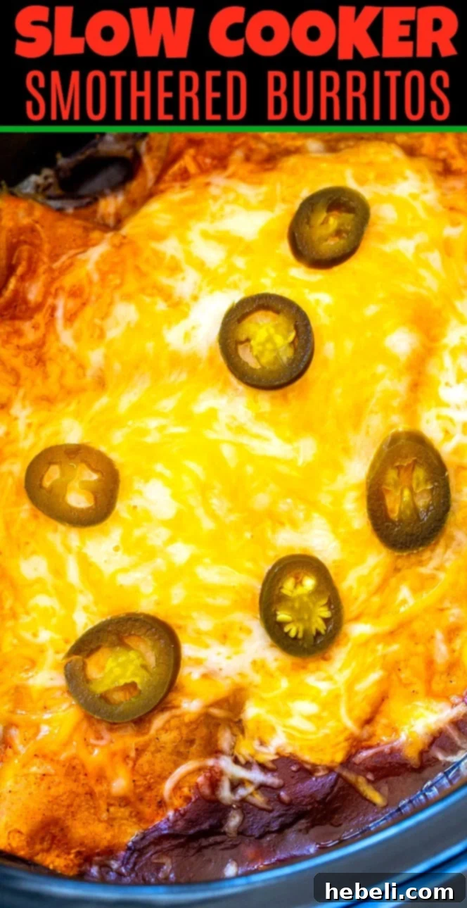 Melted cheese bubbling over Smothered Burritos in a slow cooker, fresh out of the cooker.