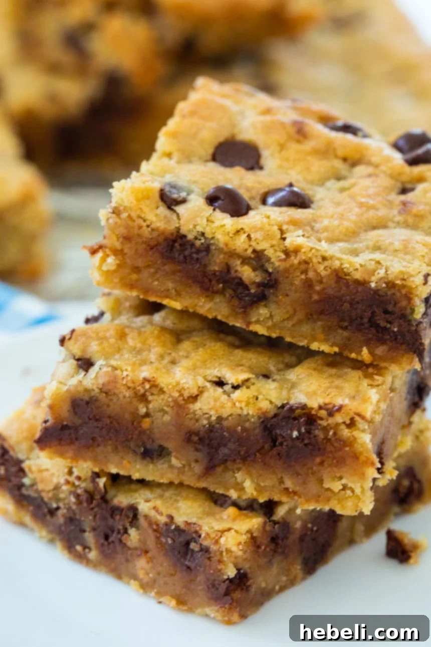 Chewy Toffee Chocolate Bars 4 A stack of golden Toffee Chocolate Chip Bars on a cooling rack, ready to be enjoyed.
