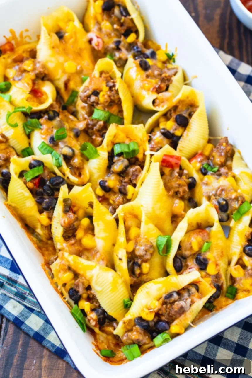 Baked Taco Stuffed Shells arranged in a baking dish, ready to be served.