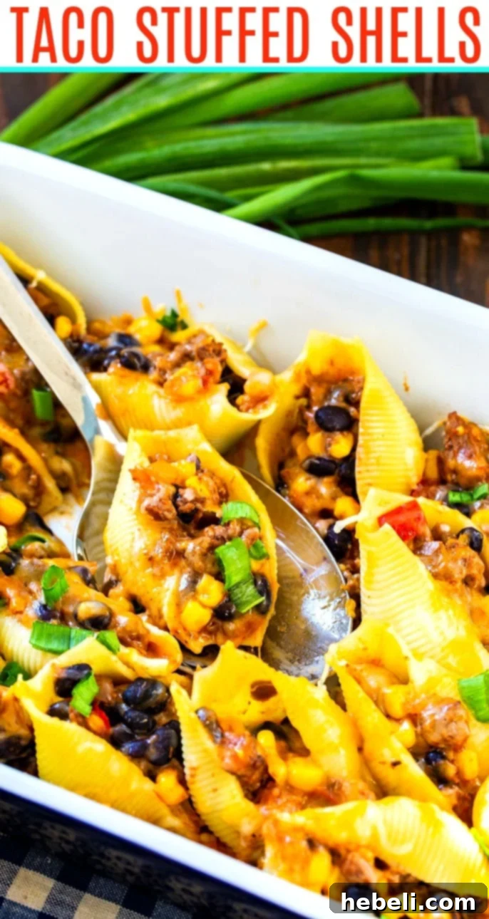 A close-up view of a pan of Taco Stuffed Shells, showing the melted cheese and colorful filling.