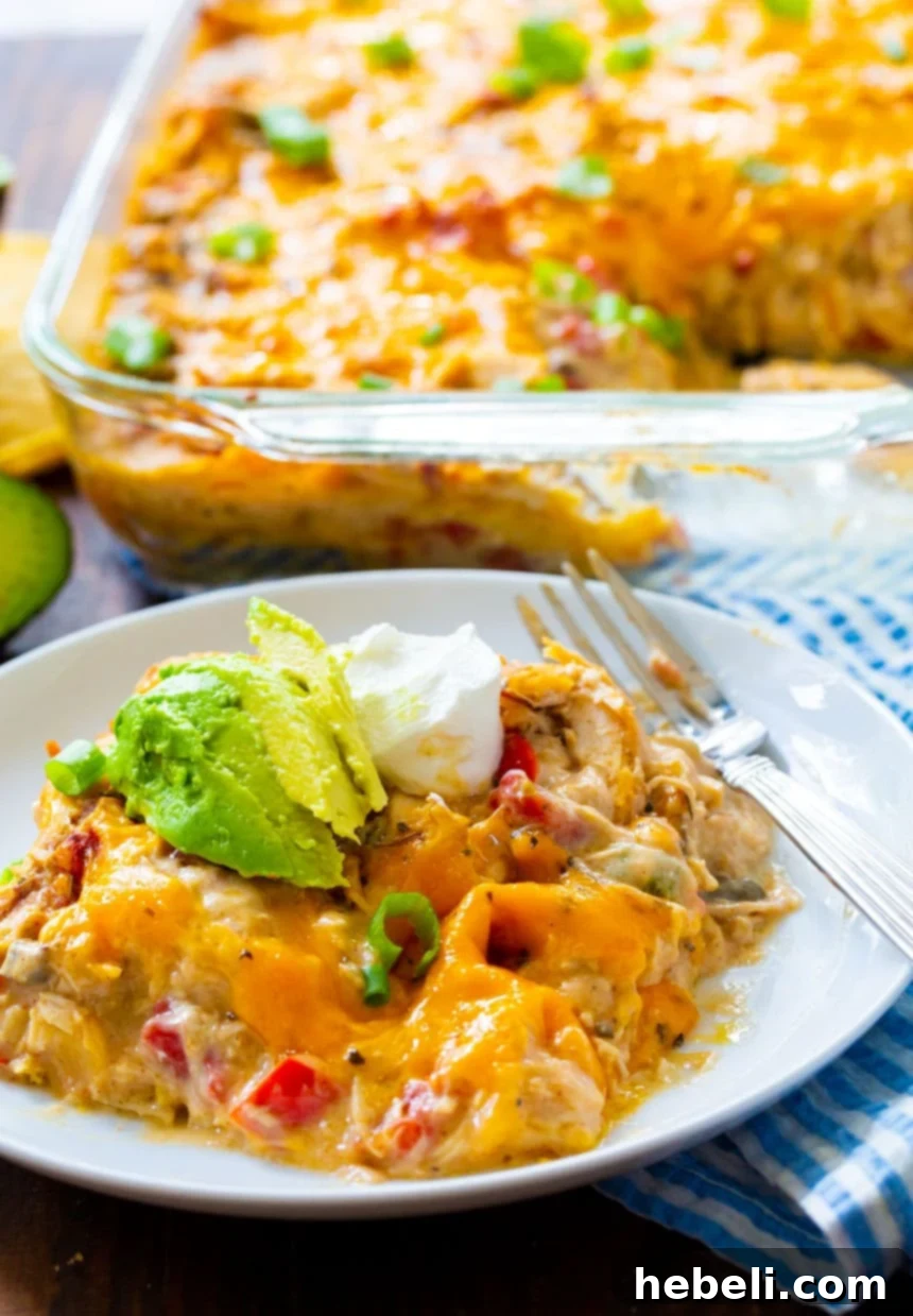 Hearty King Ranch Chicken Casserole 11 A generous serving of King Ranch Chicken Casserole on a plate, with the baking dish blurred in the background, ready for another helping.