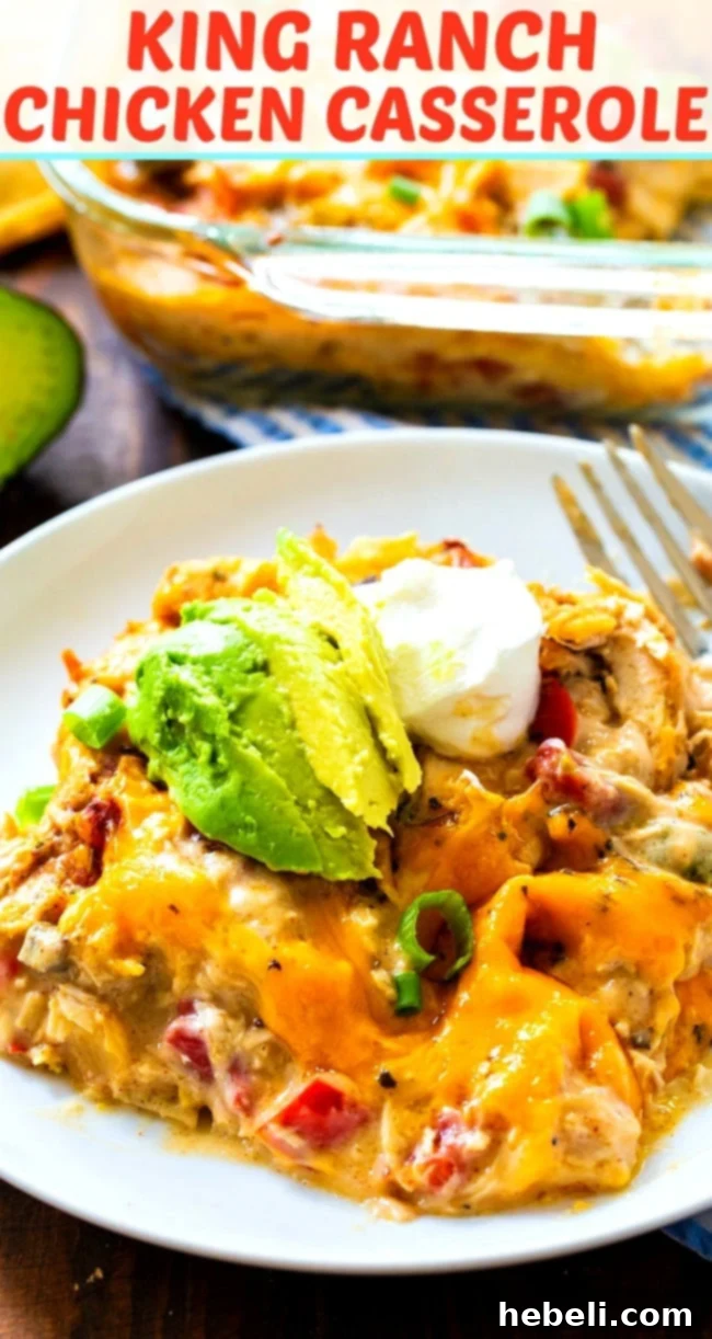 Hearty King Ranch Chicken Casserole 15 A delicious serving of King Ranch Chicken Casserole on a plate, garnished with avocado and a dollop of sour cream, with a vibrant and appealing presentation.
