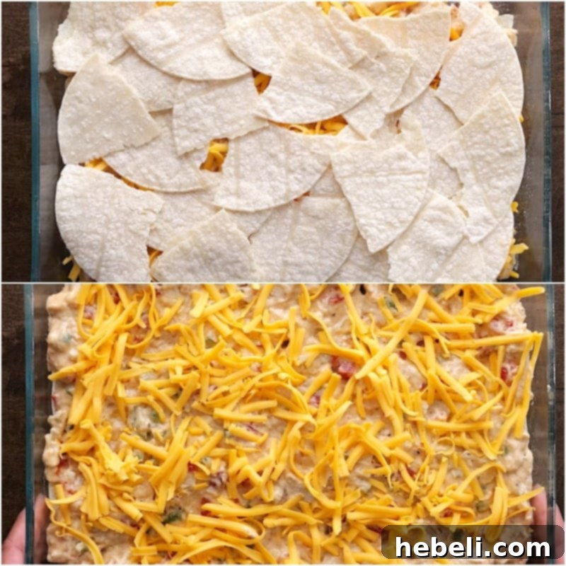 The assembled King Ranch Chicken Casserole in a baking dish, topped with cheese and ready to go into the oven.
