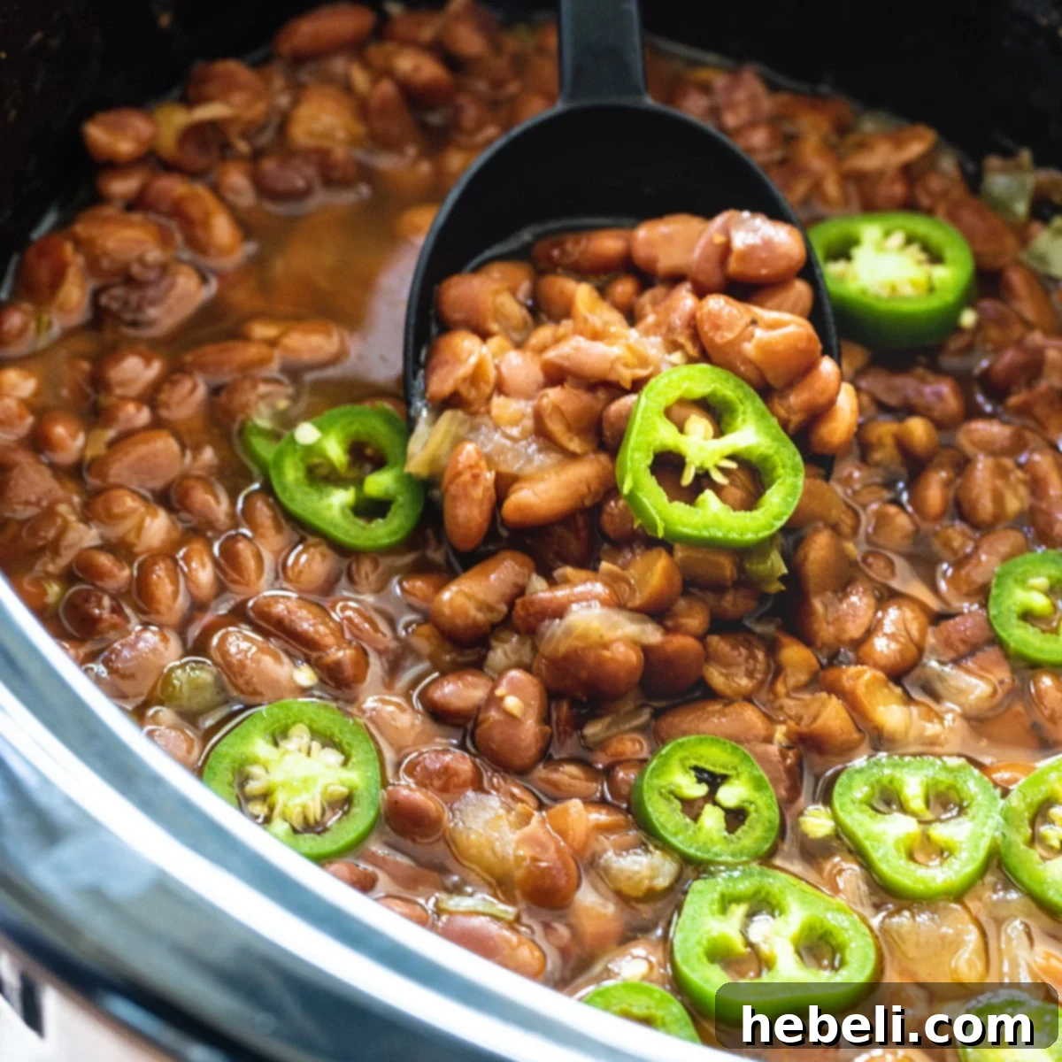 Hearty Slow Cooker Spicy Pinto Beans 2 Slow Cooker Spicy Pinto Beans in black crockpot.