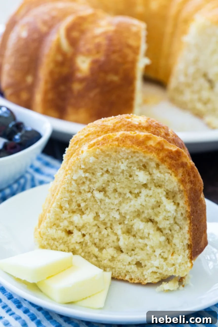 Sally Lunn: A Classic British Bake 4 A perfectly baked slice of Sally Lunn Bread on a plate with butter, ready to be enjoyed.