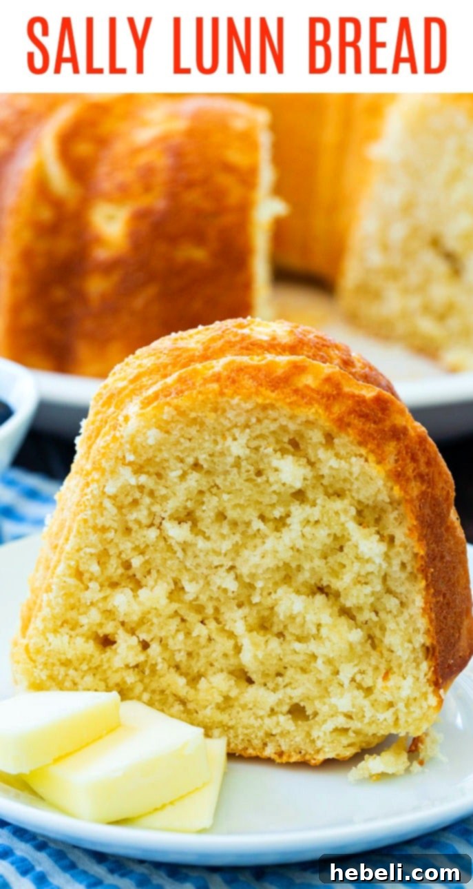 Sally Lunn: A Classic British Bake 6 A slice of Sally Lunn Bread with a pat of butter on a white plate, showcasing its fluffy texture.