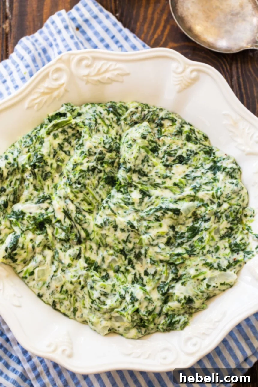 Velvety Creamed Spinach 3 Overhead shot of Creamed Spinach in a rustic bowl, showcasing its rich texture.