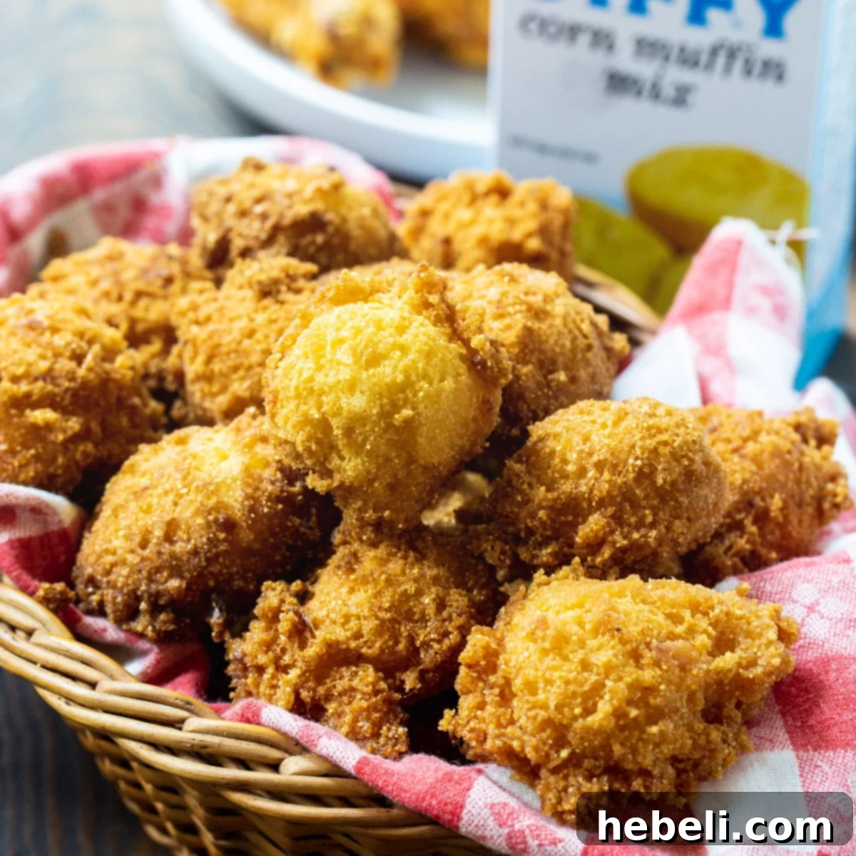 A charming basket filled with golden-brown Jiffy Hush Puppies, perfectly crispy and ready to be served.