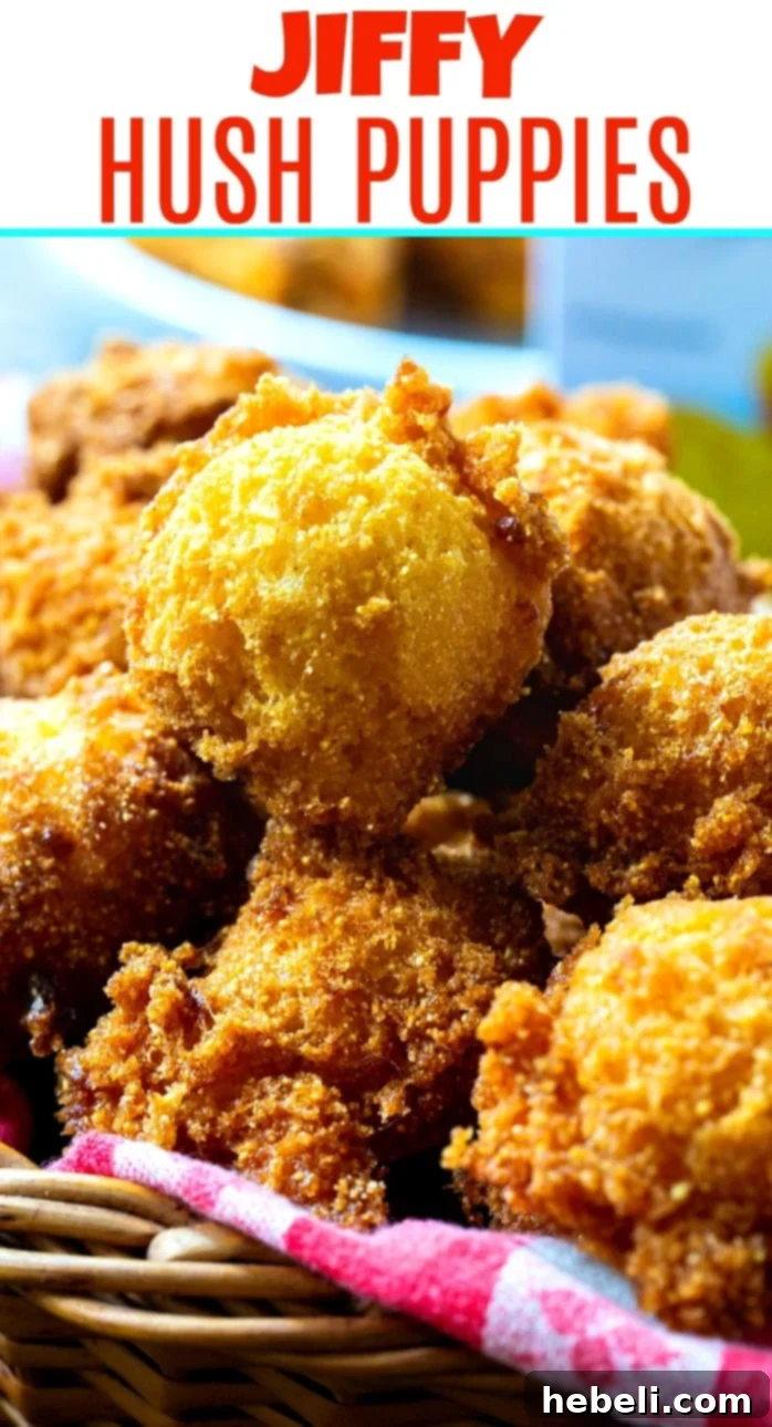 A very close-up shot of a single, perfectly golden and crispy Jiffy Hush Puppy, highlighting its appealing texture and rich color.
