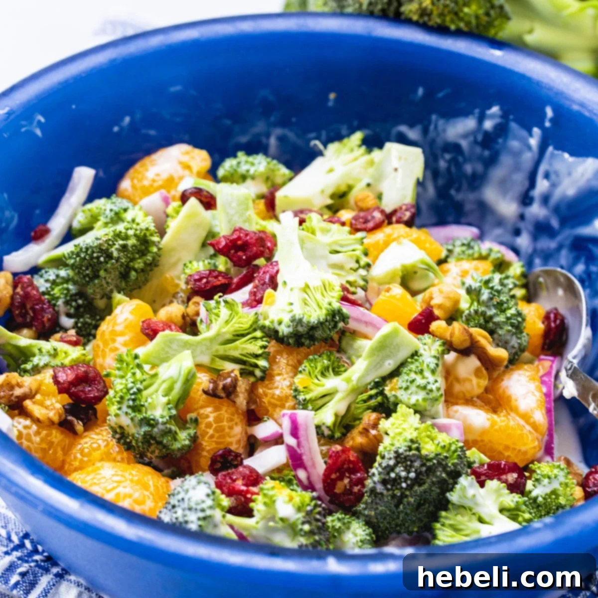 Vibrant Mandarin Broccoli Salad in a blue bowl, perfect for potlucks and summer gatherings.