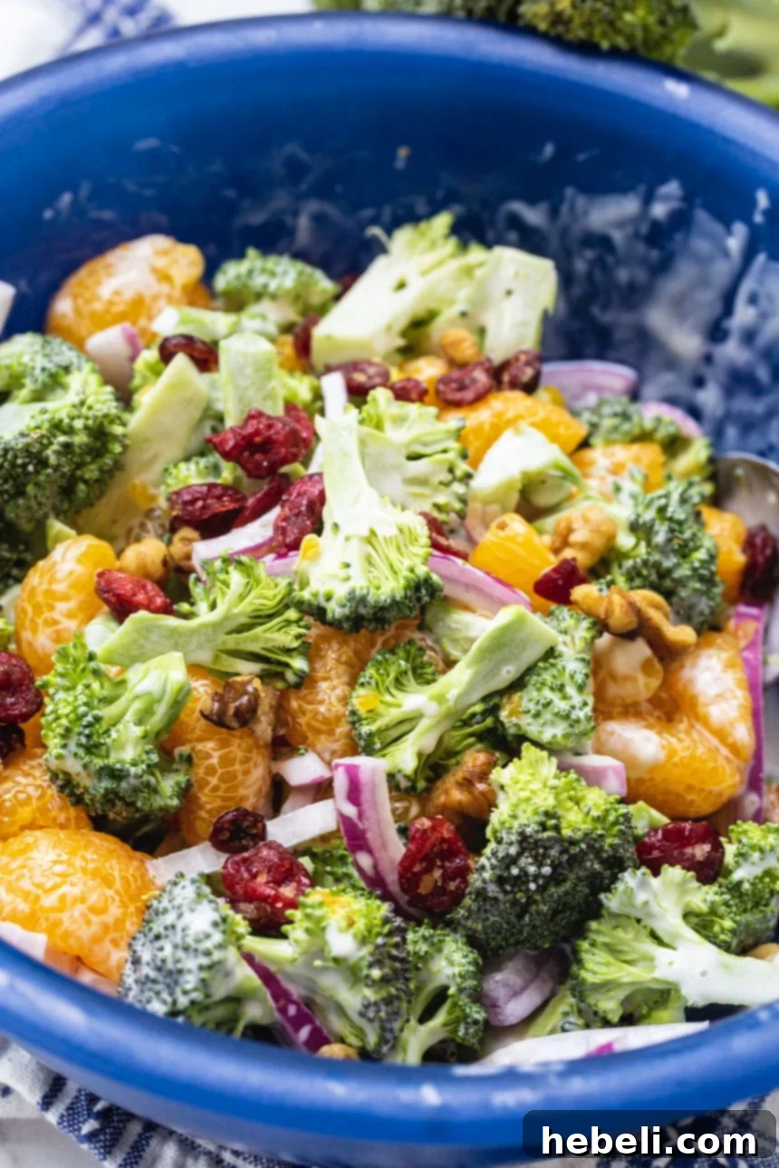 Close-up of crunchy broccoli, juicy mandarin oranges, and red onion in Mandarin Broccoli Salad.