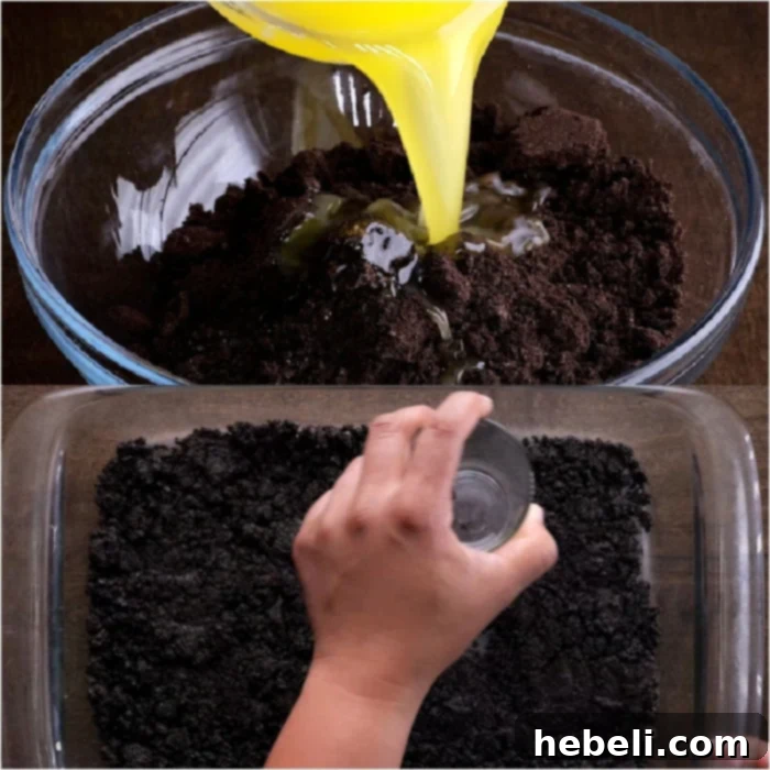 Making the Oreo crust by pressing crushed cookies and butter into a baking pan.