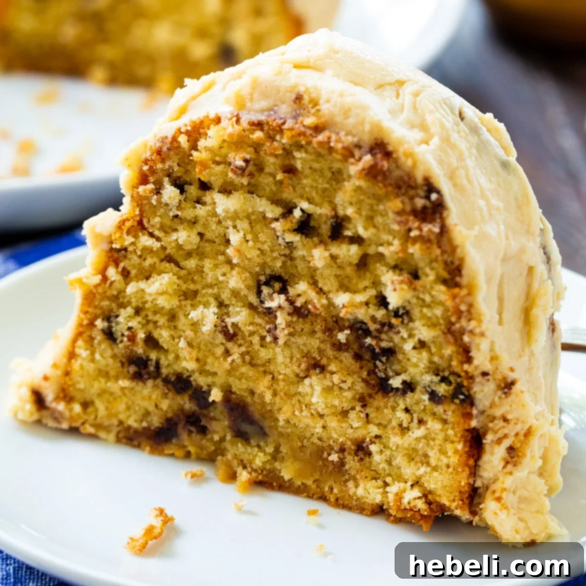Decadent Peanut Butter Bundt 2 A perfectly sliced piece of Peanut Butter Bundt Cake, revealing its moist crumb and rich peanut butter icing, served elegantly on a plate.