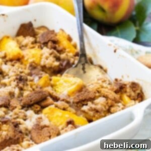 Delicious Gingersnap Peach Crisp in a white baking dish, ready to be served.