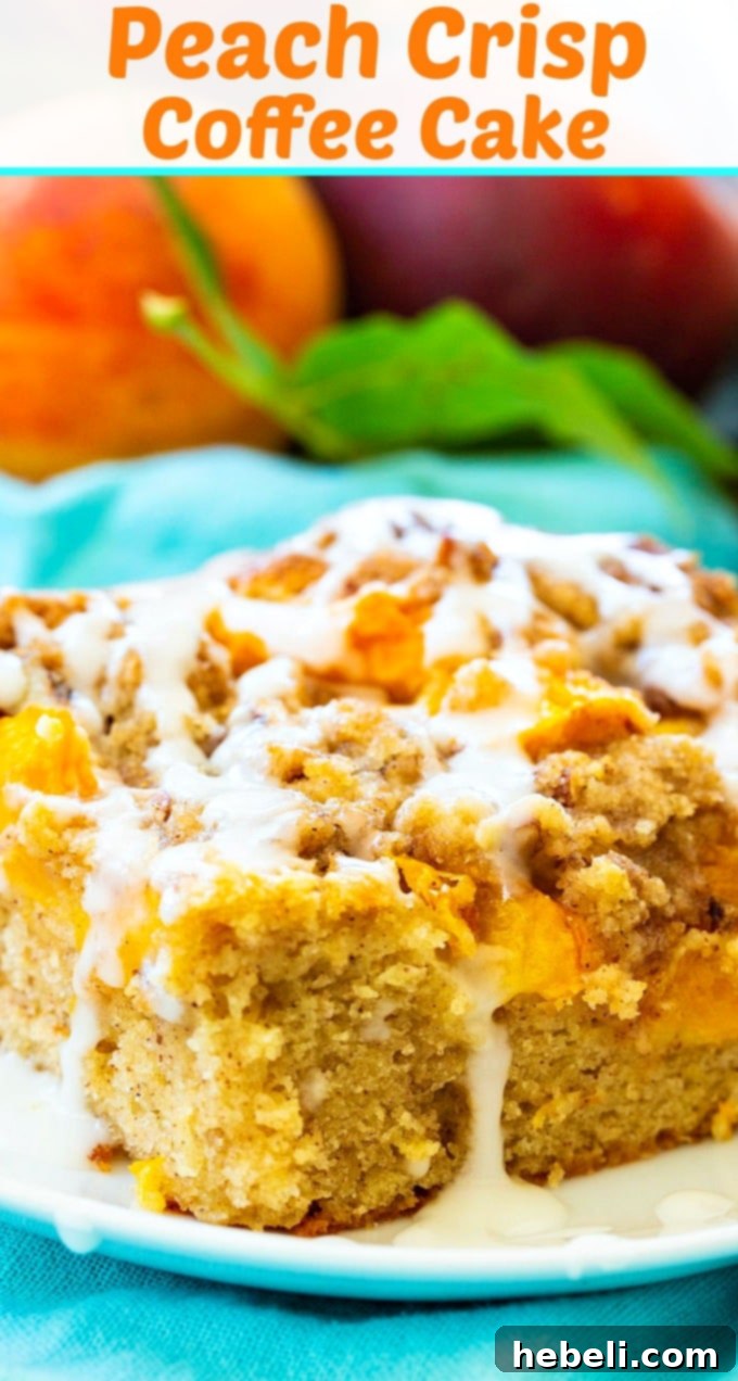 Peach Crumble Coffee Cake 6 A very close-up shot of a slice of Peach Crisp Coffee Cake, showing the individual pieces of fresh peach and the texture of the streusel and cake base, with a light glaze.