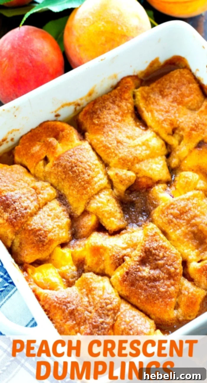 Close-up shot of several Peach Crescent Dumplings in a baking dish, highlighting their golden-brown tops and rich, bubbling sauce.
