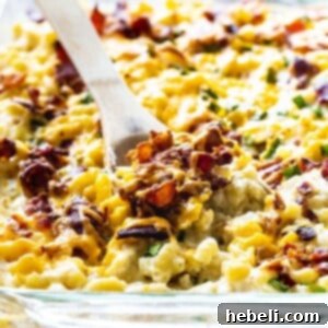 Mac and Cheese with chicken, bacon, & Ranch close-up, showing creamy texture and savory pieces.