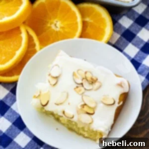 Slice of Almond Orange Sheet Cake with orange slices