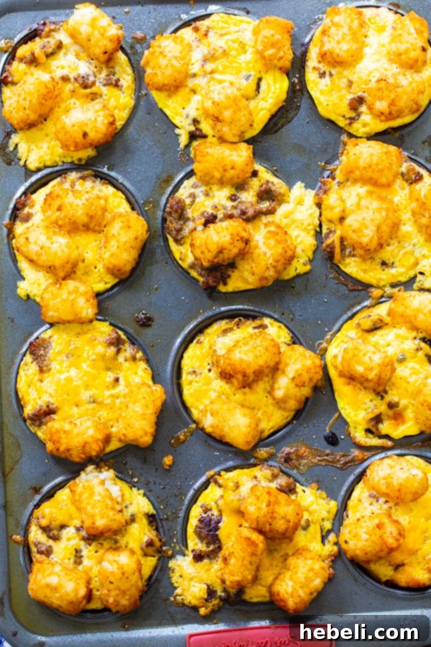 Sausage and Cheese Tater Tot Cups perfectly baked in a muffin pan, ready to be served.