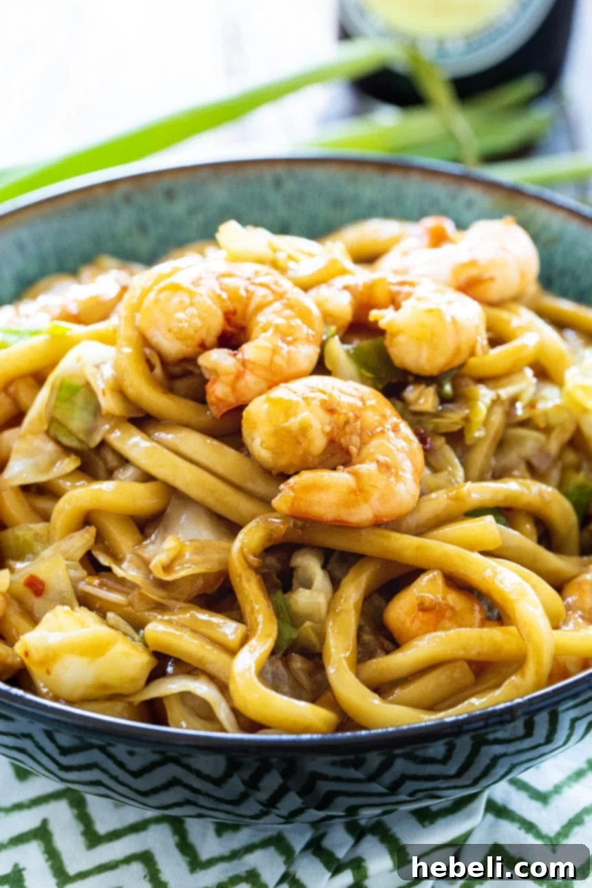 Spicy Shrimp Udon in a serving bowl, garnished with green onions.