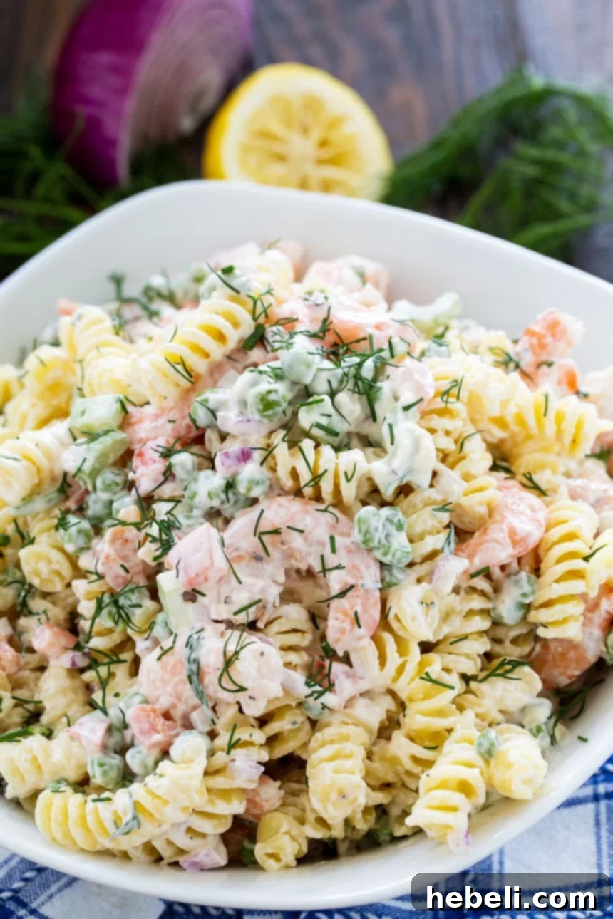 Zesty Shrimp Dill Pasta Salad 3 Close-up view of Shrimp and Dill Pasta Salad, highlighting the succulent shrimp, green peas, and fresh dill sprigs.