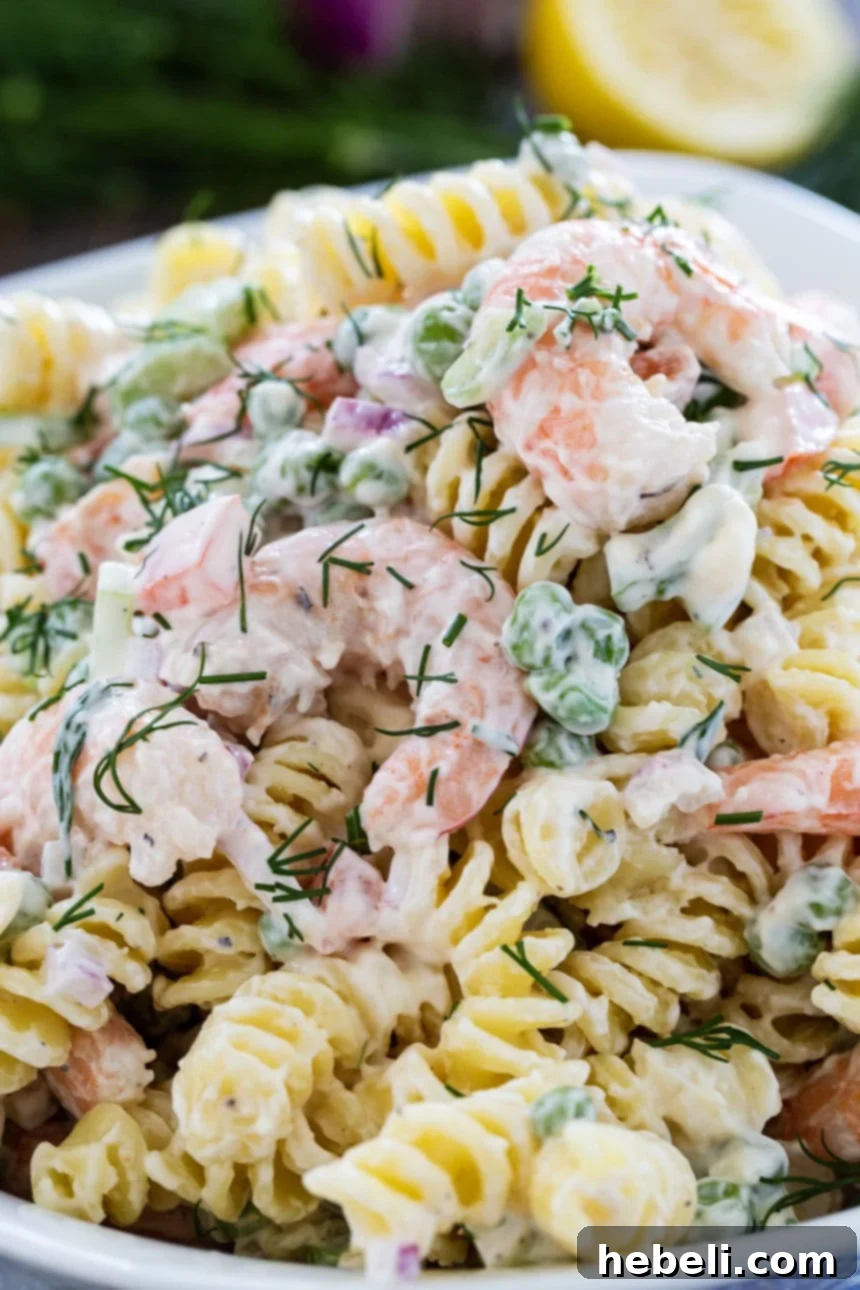 Zesty Shrimp Dill Pasta Salad 5 A beautifully presented bowl of Shrimp and Dill Pasta Salad, garnished with fresh herbs, ready to be served.