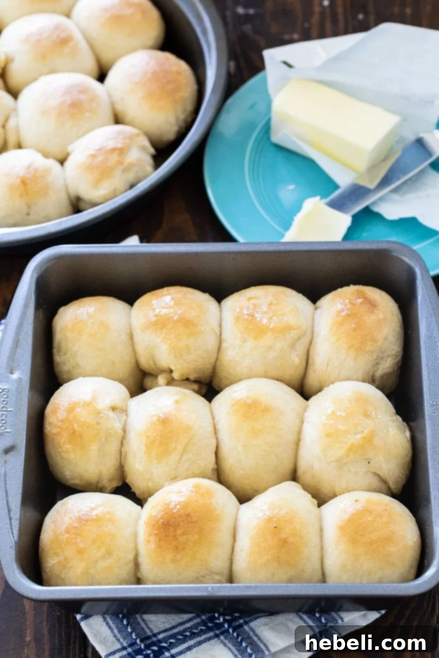 Pillowy Soft Butter Buns 3 Square baking pan filled with golden-brown Buttery Pan Rolls, freshly baked and ready to serve.