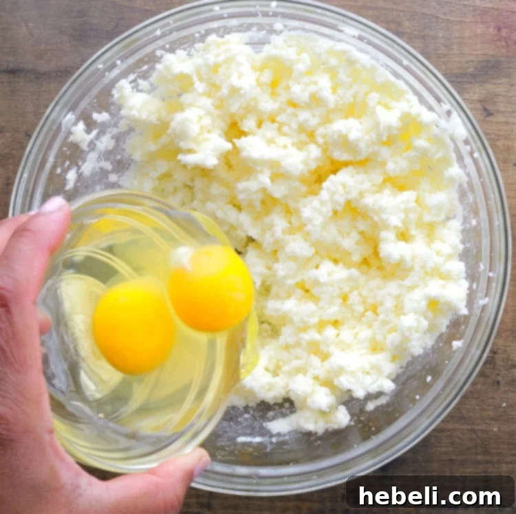 Grandma's Coca-Cola Cake 5 Adding eggs to the butter and sugar mixture for Coca-Cola cake.