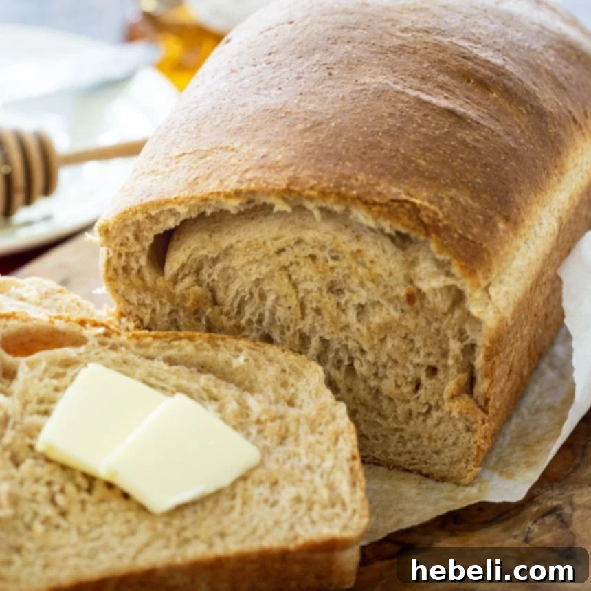 Loaf of bread with one slice cut, revealing its soft texture.