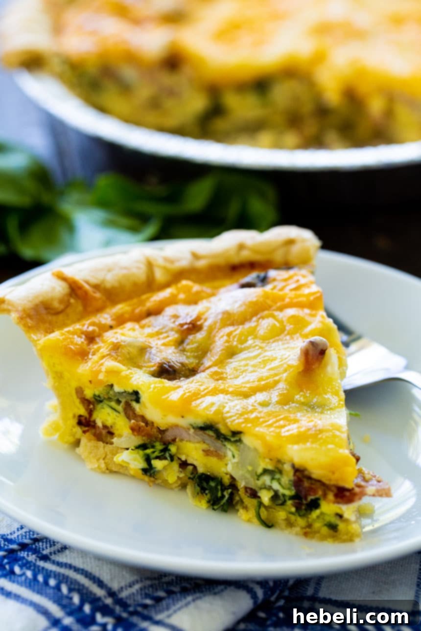 Close-up of a slice of Bacon Florentine Quiche with a golden crust.