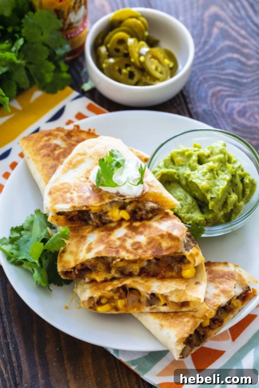 Overhead shot of two cheesy Ground Beef Quesadillas, golden brown and perfectly cooked.