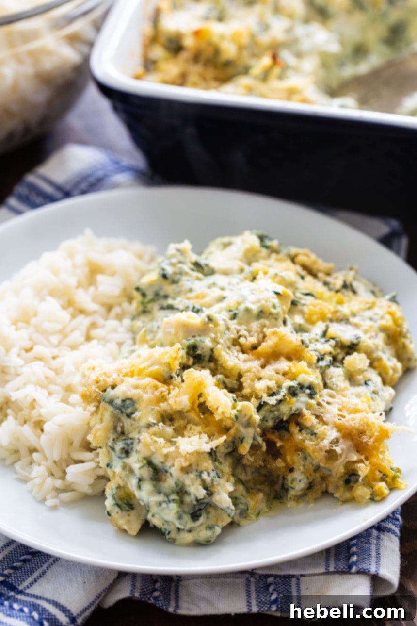 Creamy Chicken Florentine Bake 4 A generous serving of creamy chicken casserole with spinach on a plate, garnished and ready to be enjoyed.