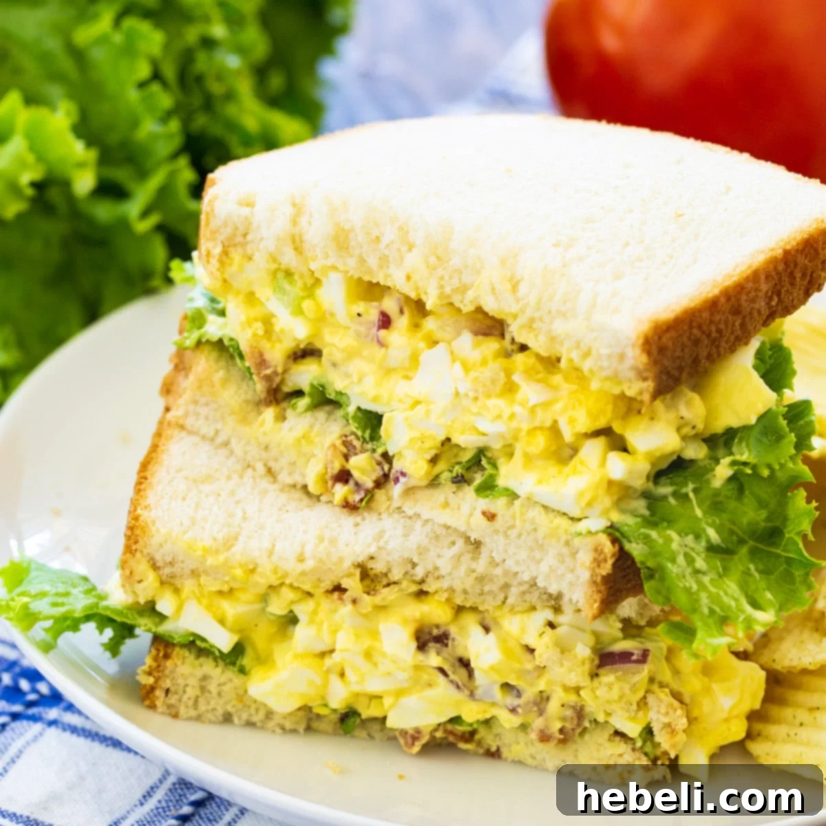 A delicious Bacon Egg Salad Sandwich served on a plate, ready to be enjoyed.