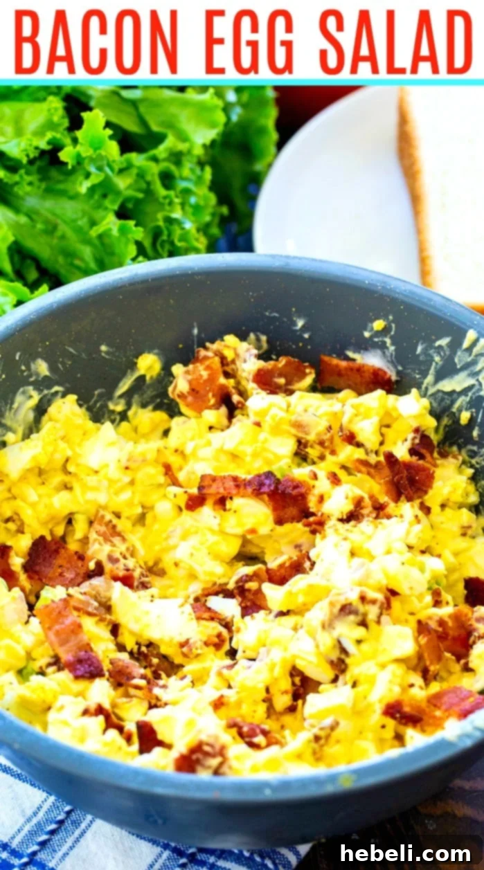 Close-up shot of Bacon Egg Salad in a blue serving bowl, highlighting the texture and bacon pieces.