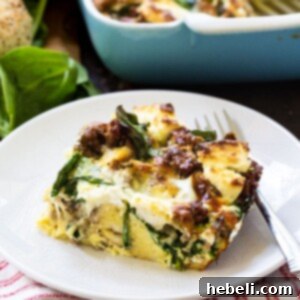 Close-up of the finished Everything Bagel Breakfast Casserole with melted cheese and cream cheese dollops.