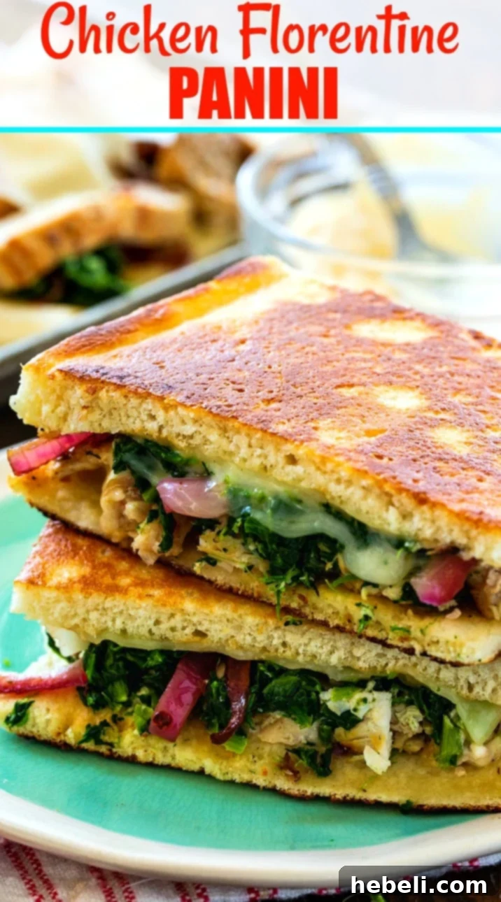 A close-up of a Chicken Florentine Panini, revealing its crispy exterior and the warm, melted cheese and vibrant fillings within.