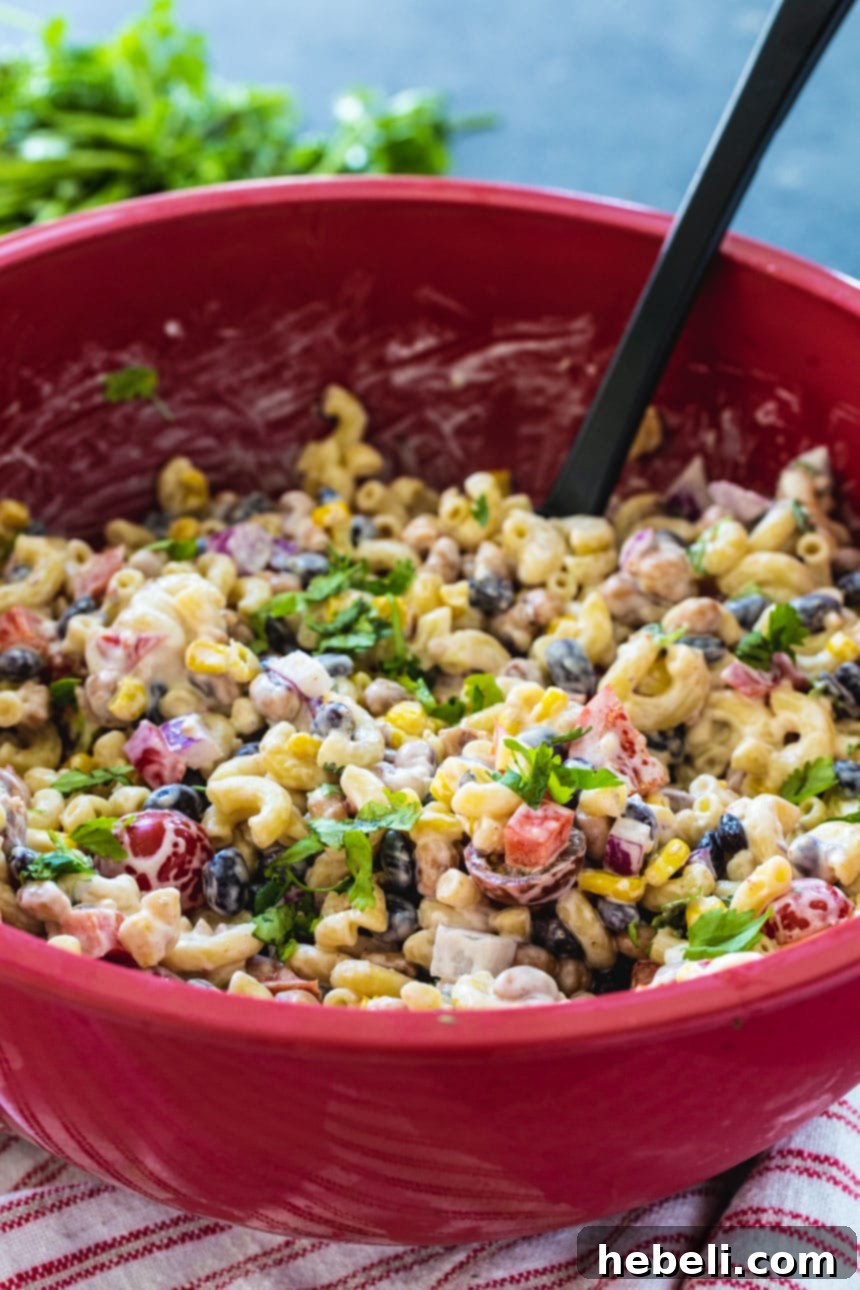 Texas Caviar Pasta Salad in a large red bowl, ready to be served.