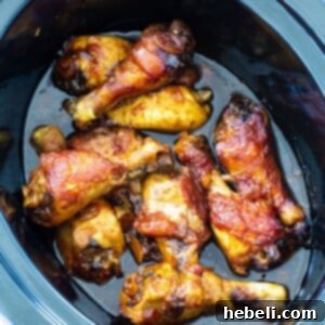 Garlic Peach Chicken Drumsticks in crock pot, fully cooked and glazed.