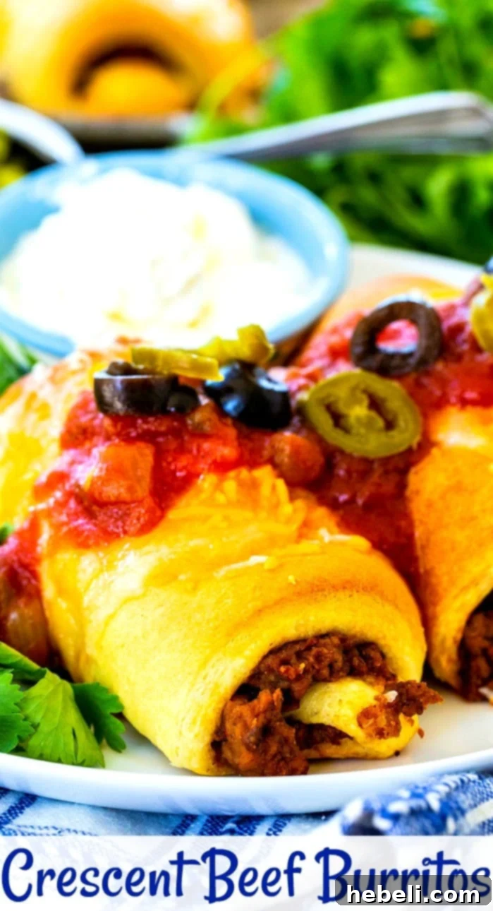 A top-down view of a golden-brown Crescent Beef Burrito with perfectly melted cheese, garnished with fresh herbs, ready for a delicious meal.