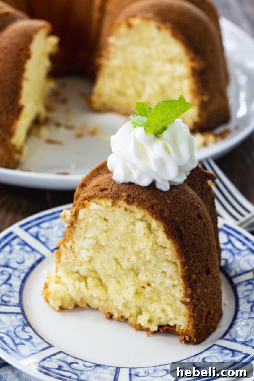 Luscious Coconut Cream Cheese Pound Cake 4 Close-up of a generous slice of Coconut Cream Cheese Pound Cake, showcasing its moist crumb.