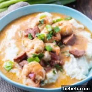 Shrimp and Grits in a blue bowl, garnished.