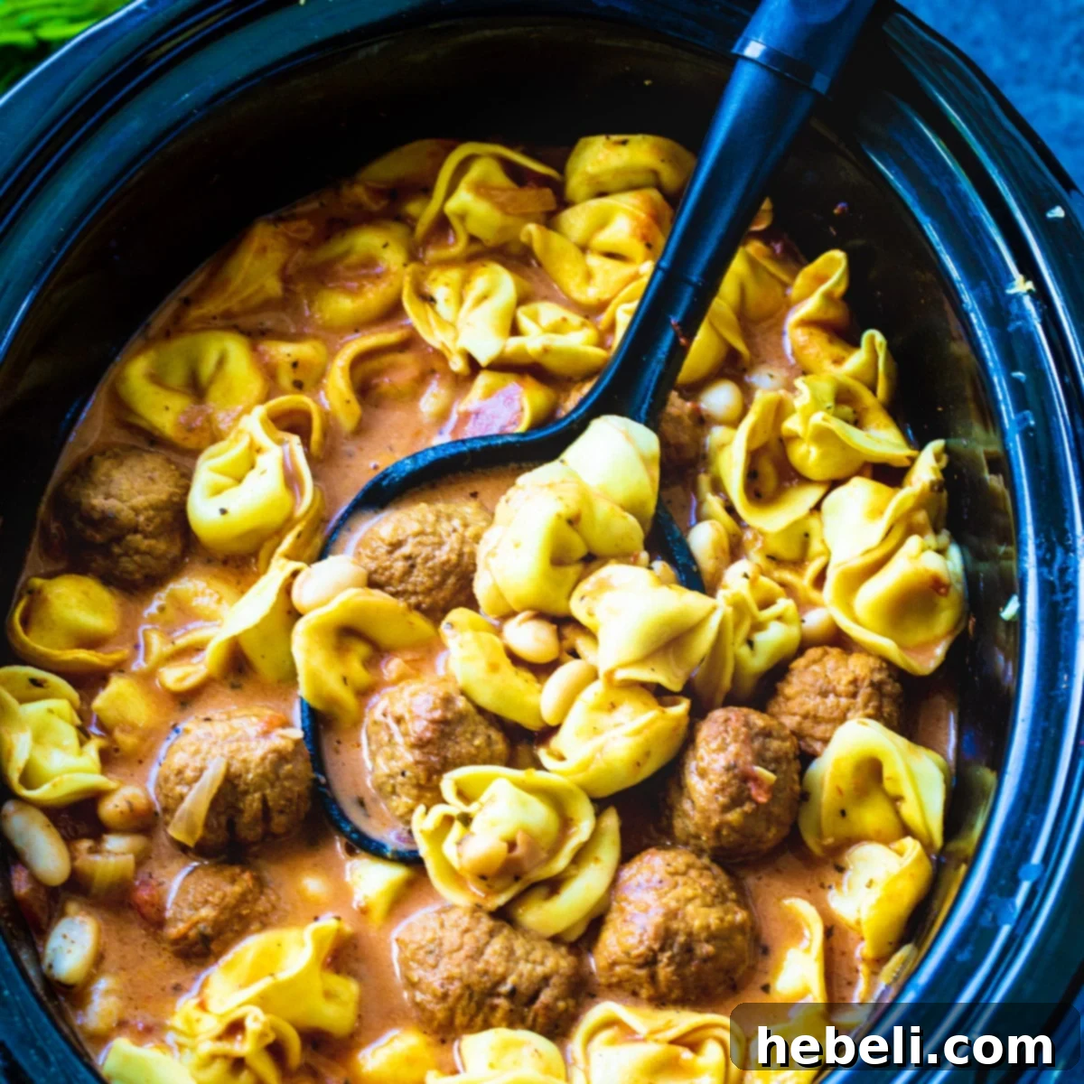 Crockpot Meatball Tortellini Soup 2 A large pot of Slow Cooker Meatball and Tortellini Soup in a slow cooker, ready to be served, showcasing the hearty ingredients.